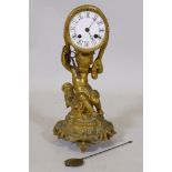 A C19th ormolu mantel clock in the form of putto bearing a drum, the enamel dial with Roman