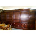 A monumental double breakfront mahogany library bookcase, comprising six upper sections of open