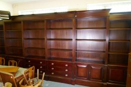 A monumental double breakfront mahogany library bookcase, comprising six upper sections of open