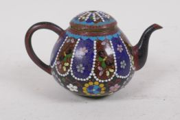 A Chinese cloisonne tea pot, decorated with gimbari style panels and butterflies and floral designs,