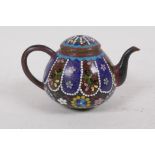 A Chinese cloisonne tea pot, decorated with gimbari style panels and butterflies and floral designs,