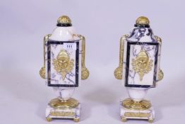 A pair of marble urns with ormolu mounts, 32cm high