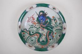 A famille verte porcelain charger decorated with a dragon and flaming pearl, Chinese Kangxi 6