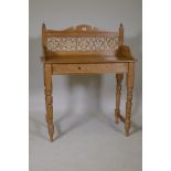 A Victorian stripped pine washstand with tiled back, raised on turned supports, 88 x 45 x 109cms