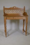 A Victorian stripped pine washstand with tiled back, raised on turned supports, 88 x 45 x 109cms