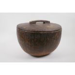 A large African carved wood container and cover, 35cm diameter