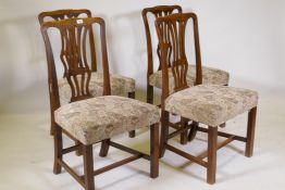 Four early C19th mahogany Chippendale style chairs with pierced splats, raised on square supports