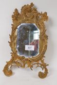 An ormolu brass easel frame with inset mirror, lacks back stay, stamped No.122, 31cm high