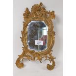 An ormolu brass easel frame with inset mirror, lacks back stay, stamped No.122, 31cm high