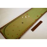 A C19th mahogany cased folding bagatelle table with baize lined interior and various balls, AF 2