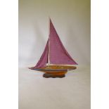 A wood model of a yacht, mounted on a stand, 125cm long, 142cm high