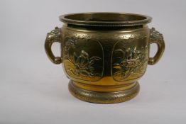 An oriental bronze vessel, with cast decoration and kylin handles, seal mark to base, 30cm diameter,