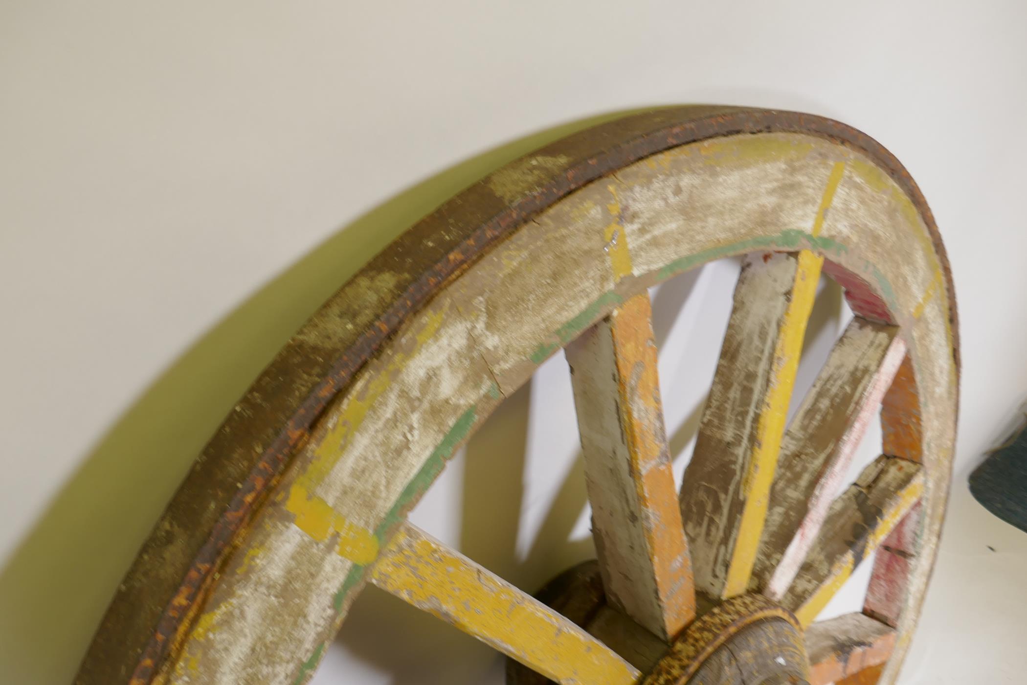 An Indian painted wood and iron bound cartwheel, 47" diameter - Image 3 of 4