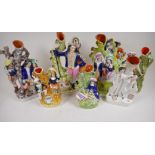 Seven Staffordshire flat back spill vases modelled as various figures