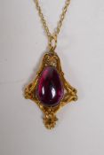 A yellow metal Art Nouveau style pendant on chain set with a purple coloured stone, 4cm long, 9.3g