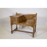 An oak hall settle, with carved panel back and cupboard, raised on turned supports, 87 x 50 x