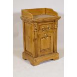 A satin walnut bedside cabinet with galleried top over single drawer and magazine rack base, 77 x 48