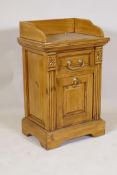 A satin walnut bedside cabinet with galleried top over single drawer and magazine rack base, 77 x 48