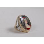 A 925 silver ring set with an enamel panel depicting a girl in red, approx size N/O