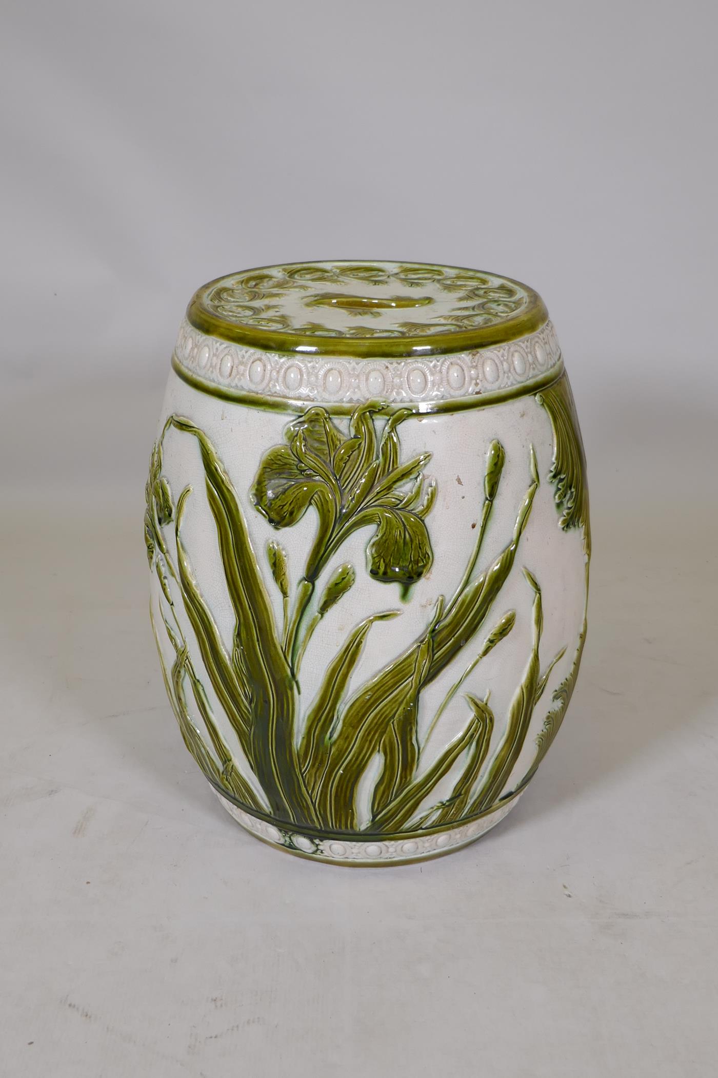 A Wardle majolica garden seat with raised olive green glazed lily decoration, 47cm high, 36cm