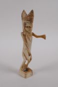 An antique Indonesian carved bone ceremonial figure, 15cm high
