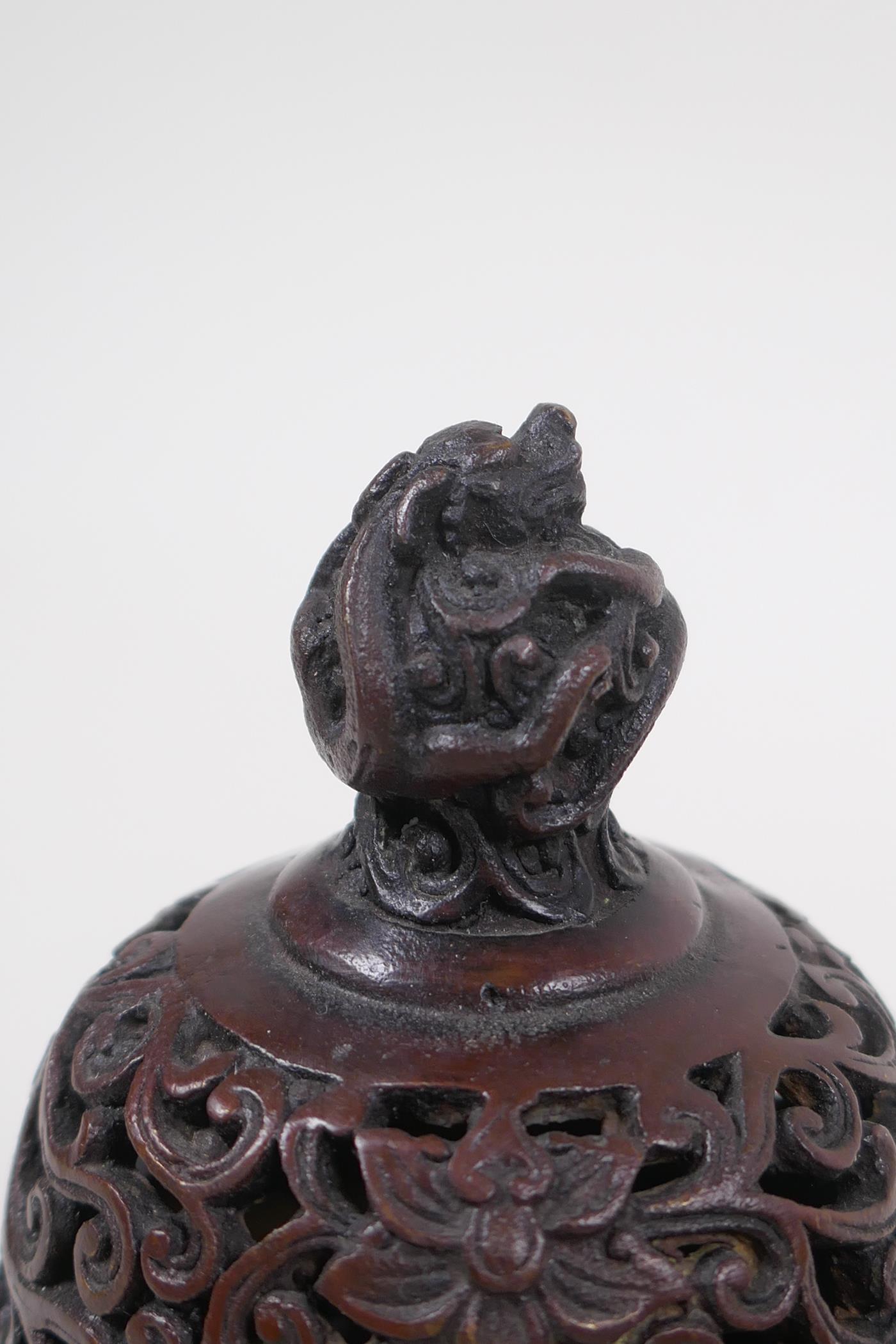 A Chinese bronze two handled censer and cover, with dragon knop and handles, raised on tripod - Image 4 of 5