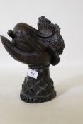 An oriental hardwood carving of a hand bearing a cabbage, 27cm high