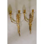 A pair of ormolu Empire style two branch wall sconces, 39cm high