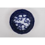 A Chinese powder blue ground dish of lobed form with white phoenix decoration, 18cm diameter