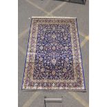 A rich blue ground full pile Kashmir carpet with an all over floral design, 240cm x 160cm