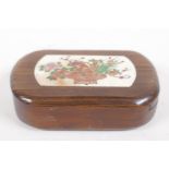 An oriental hardwood box, the sliding cover inset with engraved and inked bone panel, 10cm long