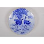 A Japanese blue and white porcelain cabinet plate decorated with cranes, inscription to the base,