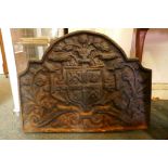 An antique cast iron fire back decorated with a coat of arms, 68 x 52cm