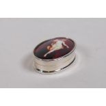 A sterling silver pill box set with a cold enamel panel depicting a female nude, 4 x 2.5cm