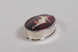 A sterling silver pill box set with a cold enamel panel depicting a female nude, 4 x 2.5cm