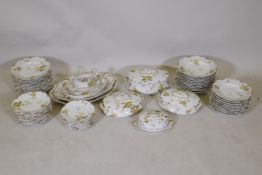 An antique Limoges part dinner service with yellow floral decoration and gilt details, AF faults,