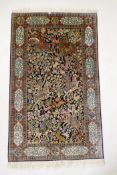 A caucasian fine silk rug with a leopard hunt design on a blue field, the red borders decorated with