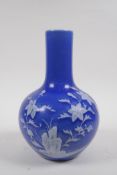 A blue glazed porcelain bottle vase with raised white enamel floral decoration, Chinese Qianlong