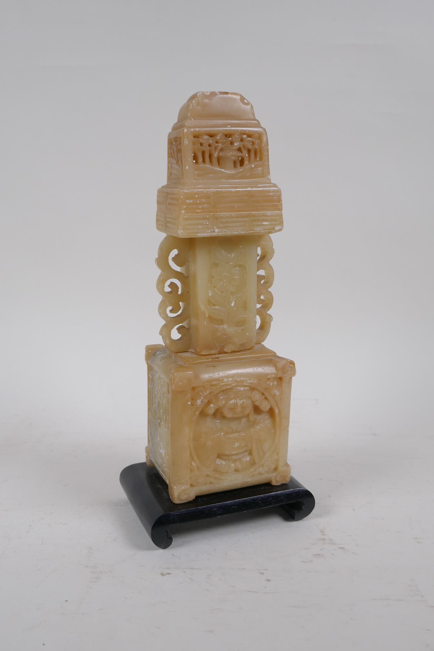 A Chinese carved soapstone stand, mounted on a wood base, 25cm high