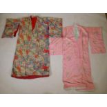 An early C20th Japanese padded silk kimono with a fan and flower design, and another crushed silk