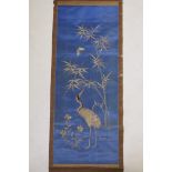 A late C19th/early C20th Japanese silver thread on silk embroidered scroll depicting a red crowned