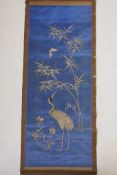 A late C19th/early C20th Japanese silver thread on silk embroidered scroll depicting a red crowned