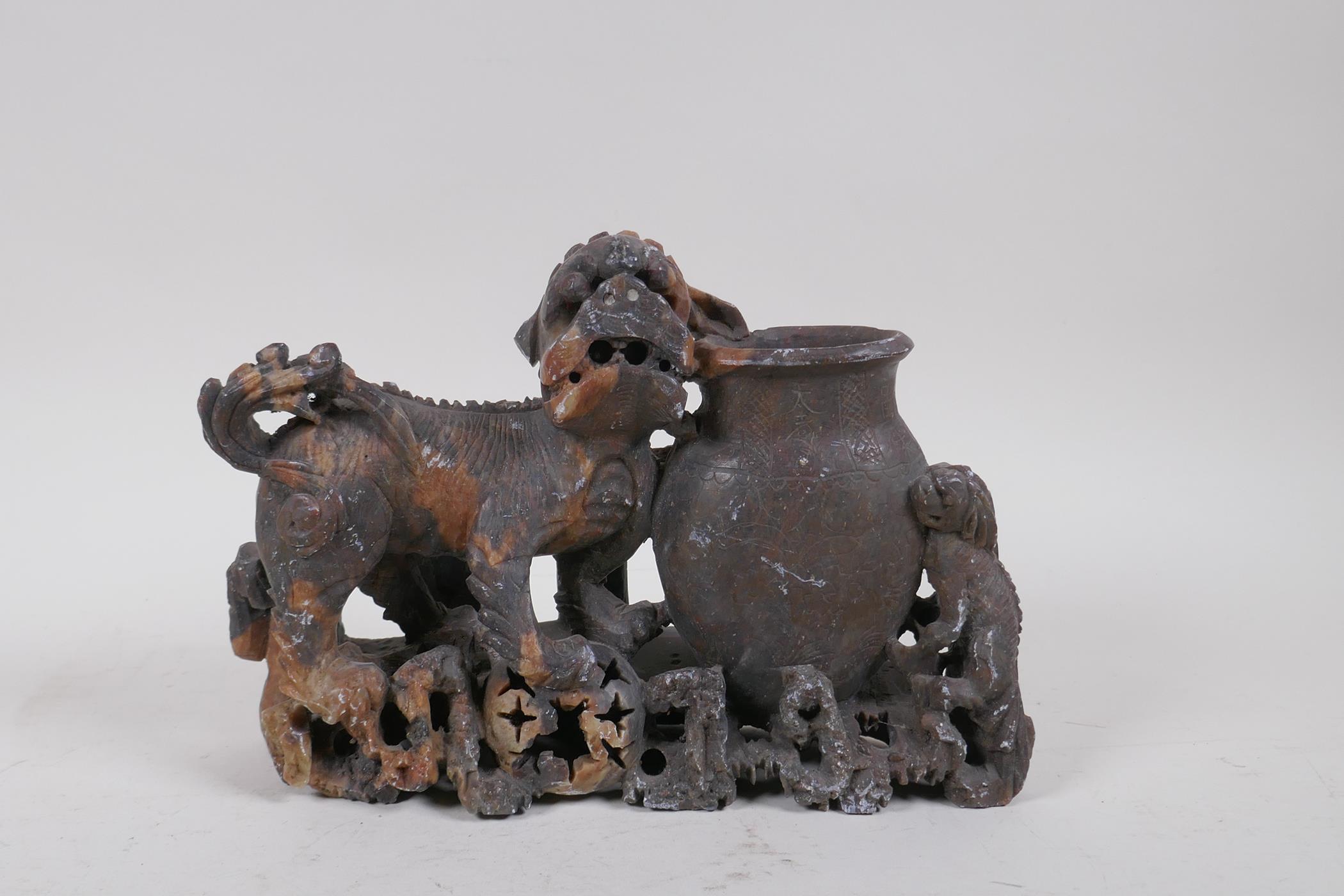 A Chinese soapstone carving of a fo dog and vase, 25cm long