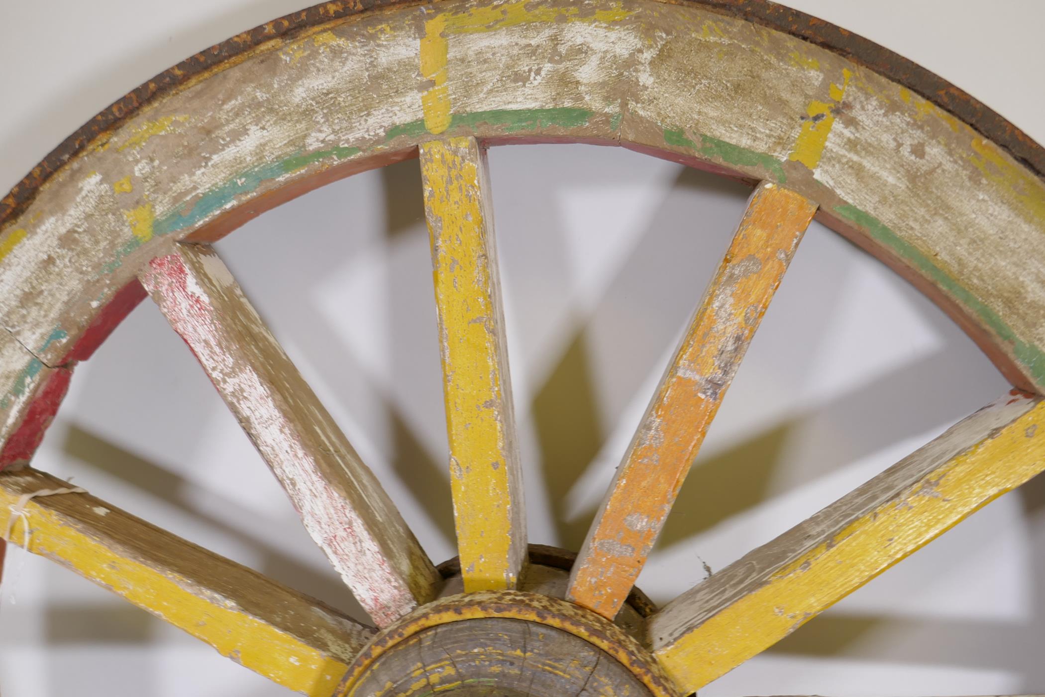 An Indian painted wood and iron bound cartwheel, 47" diameter - Image 4 of 4