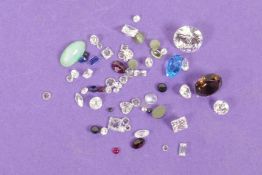 A collection of small gemstones including sapphires and jade