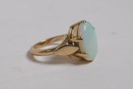 A 9ct yellow gold ring set with a large opal, 4.5g, size L