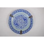 A C19th Chinese blue and white porcelain dish with lobed rim, metal straps and phoenix decoration,