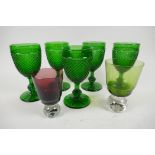 A set of five green pressed glass wine goblets with hobnail design, 16cm, together with two coloured