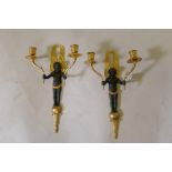 A pair of bronze and ormolu two branch wall sconces in the form of putti bearing cornucopia, 35cm
