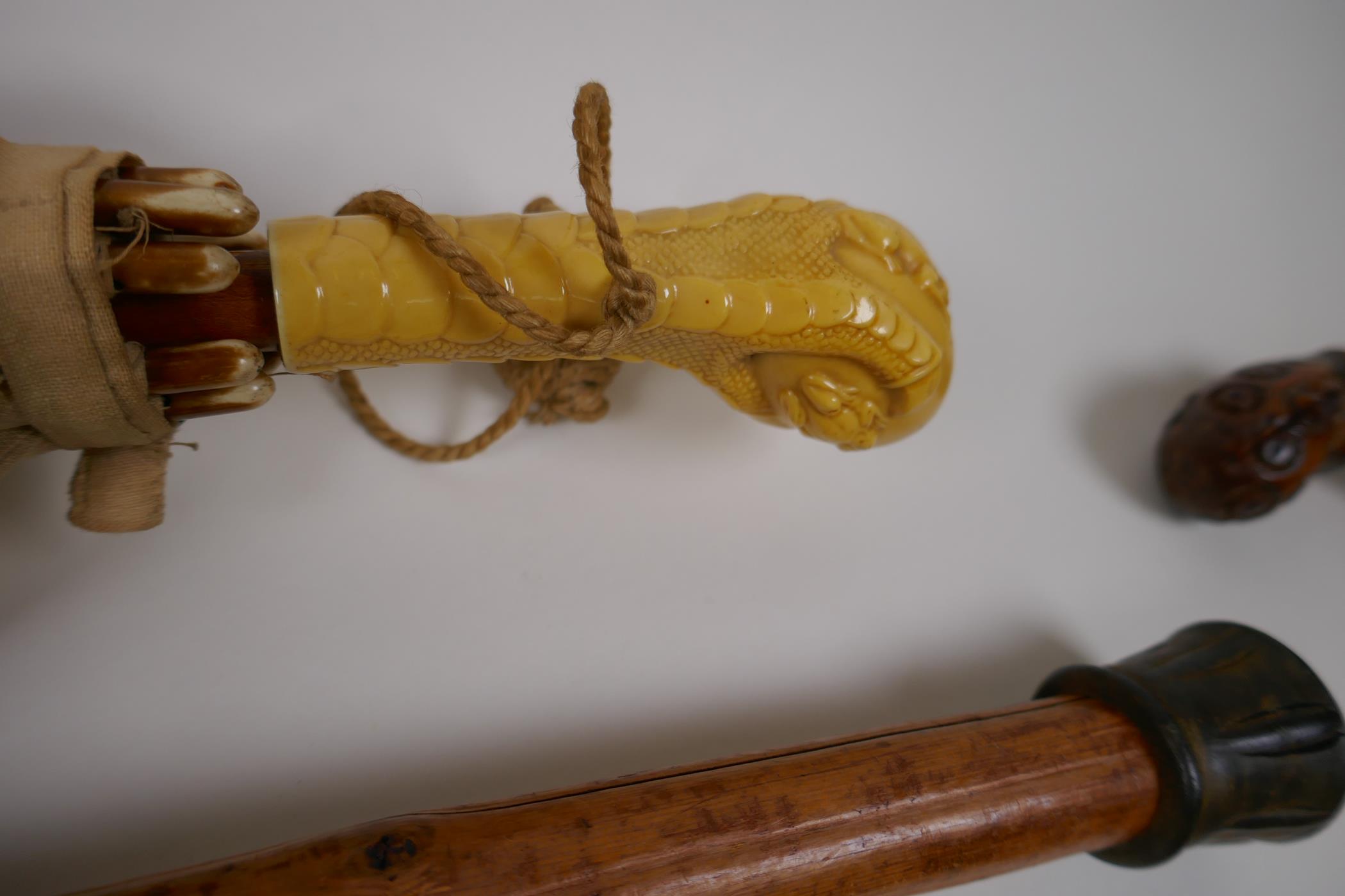 A collection of walking sticks including an ebonised stick with a hallmarked silver cuff, and a horn - Image 4 of 5